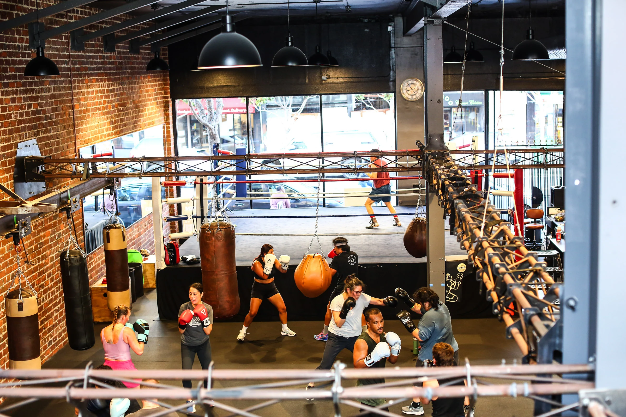 An elevated view of GGG's boxing ring and members training on the heavy bags