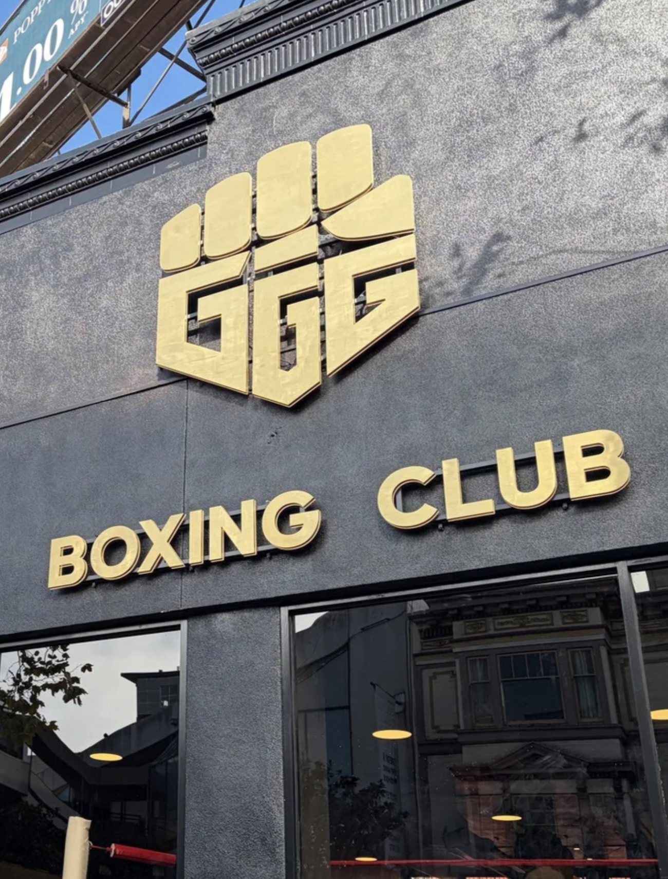 The gold GGG Boxing Club sign on the black storefront at 1436 Polk Street